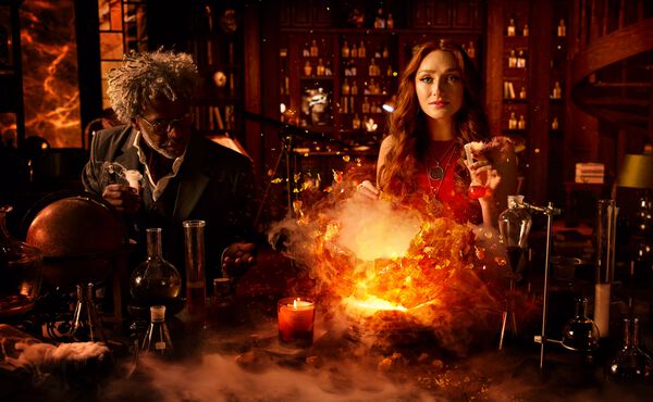 Two ancient alchemists conjuring magic using potions and chemistry aparatus in a charming workshop filled with bottles.